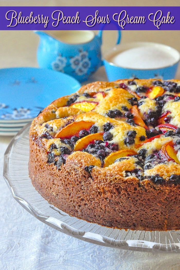 Blueberry Peach Sour Cream Cake photo of uncut cake with title text added for Pinterest