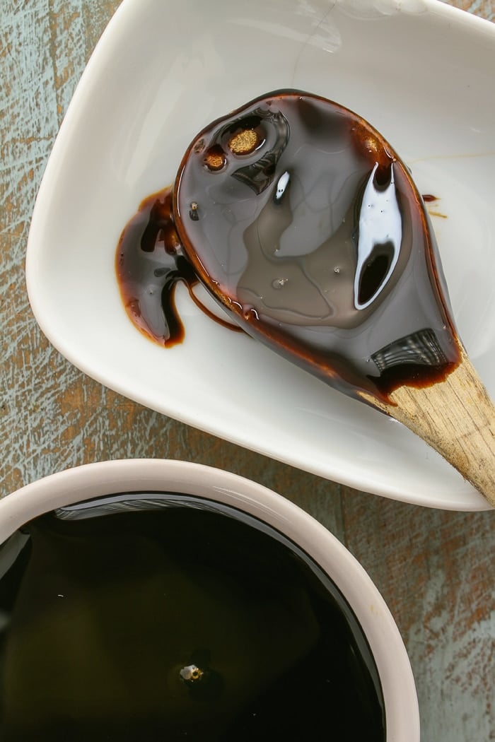 Molasses on a wooden spoon. Stock photo