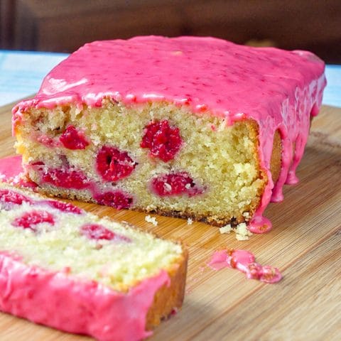 Raspberries and Cream Loaf Cake sliced to whole raspberries inside