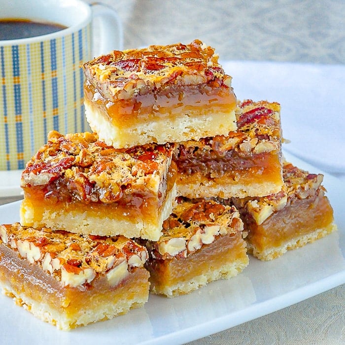 The Best Pecan Pie Bars wide shot on a white plate