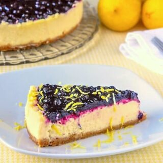 Sour Cream Blueberry Lemon Flan photo of a single slice on a white plate.