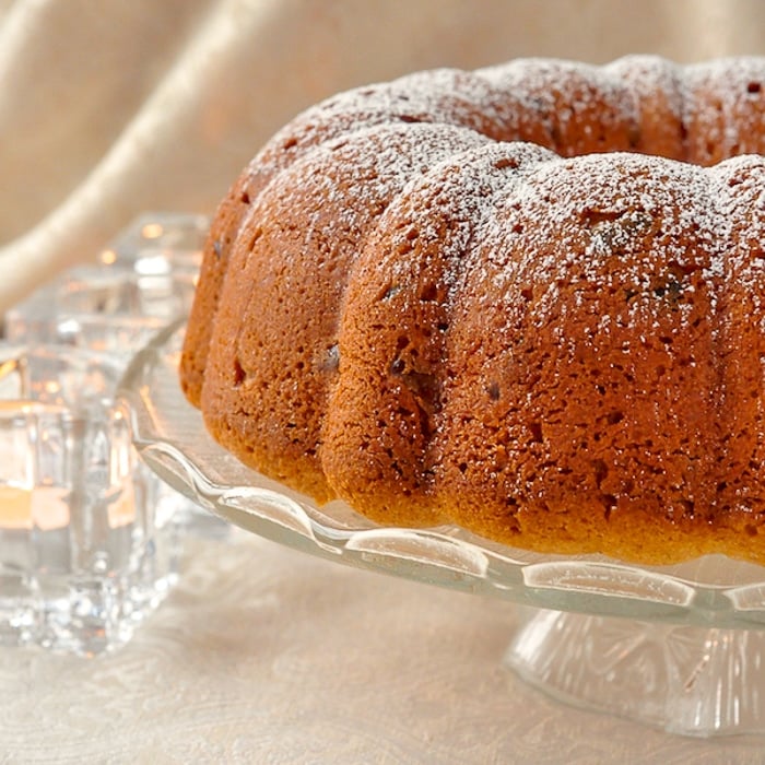 Uncut Gumdrop cake on a clear glass pedestal