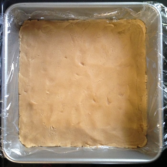 Line the pan with plastic wrap and press cookie dough into pan.
