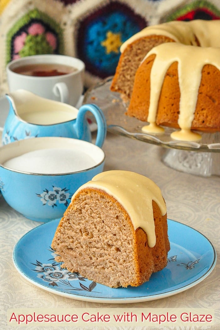 Applesauce cake photo of one slice with a blue tea service in background with title text added for Pinterest