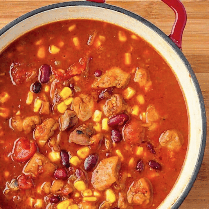 Close up photo of Chicken Chili Rice and Beans in a red dutch oven.