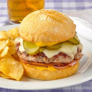 Cuban Sandwich Burger pictured with potato chips and beer