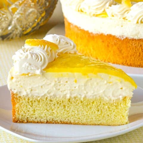 Lemon Mousse Cake photo of a single slice on a white plate