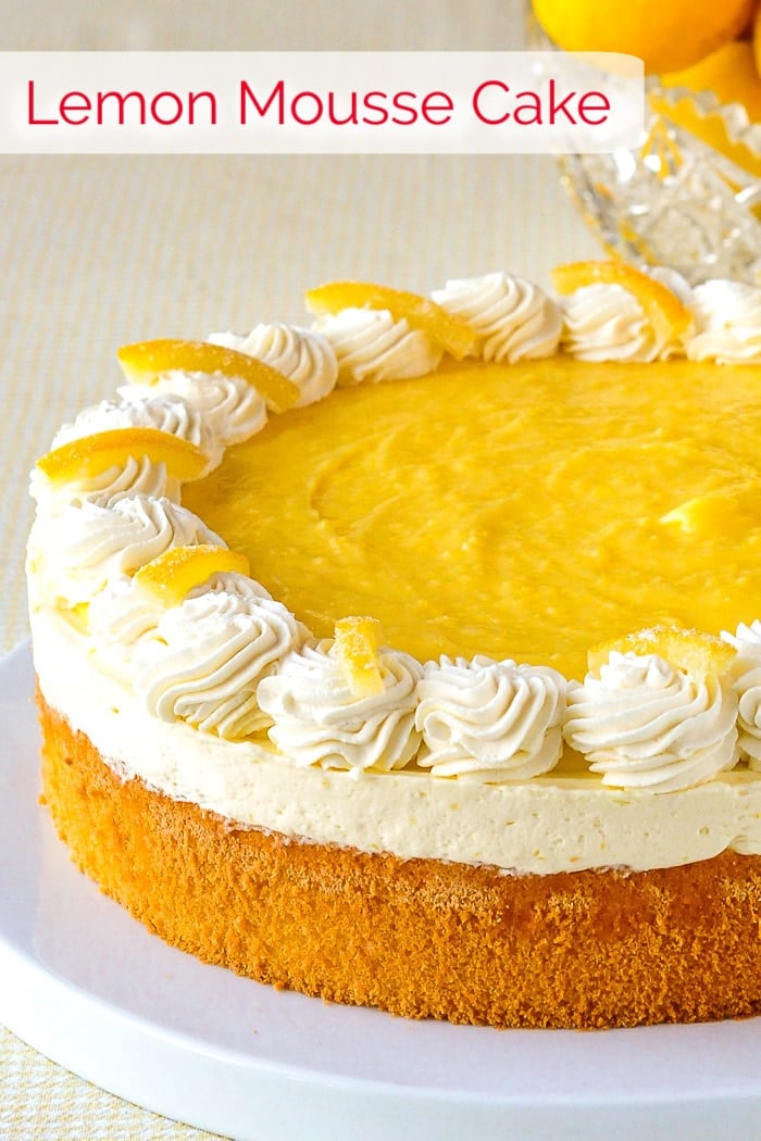 Lemon Mousse Cake photo of uncut cake with title text added for Pinterest