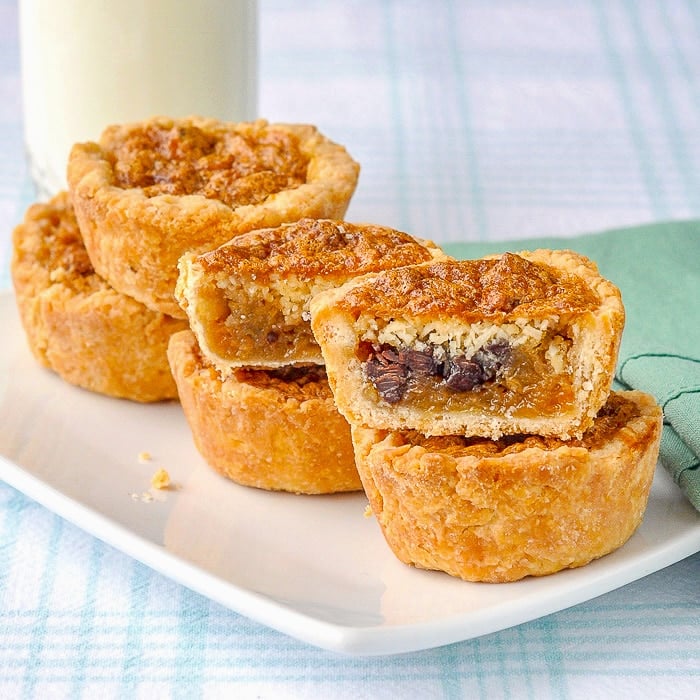 Loaded Butter Tarts with glass of milk in background