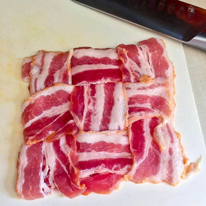An uncooked woven bacon blanket