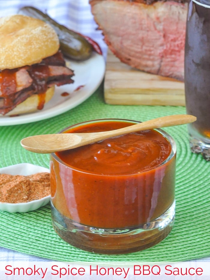 Smoky Spice Honey Barbecue Sauce in a clear glass serving dish with title text added for Pinterest