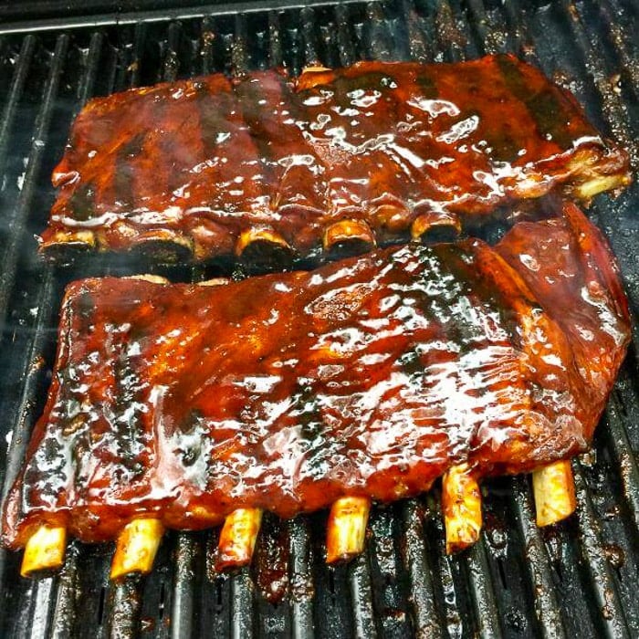 Smoky Spice Honey Barbecue Sauce on ribs being grilled