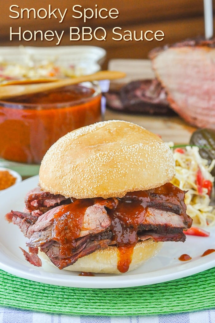 Smoky Spice Honey Barbecue Sauce photo of sliced beef sandwich with title text added for Pinterest
