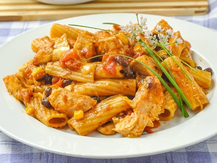 BBQ Chicken Pasta Bake wide shot of an entire serving with garlic flower garnish