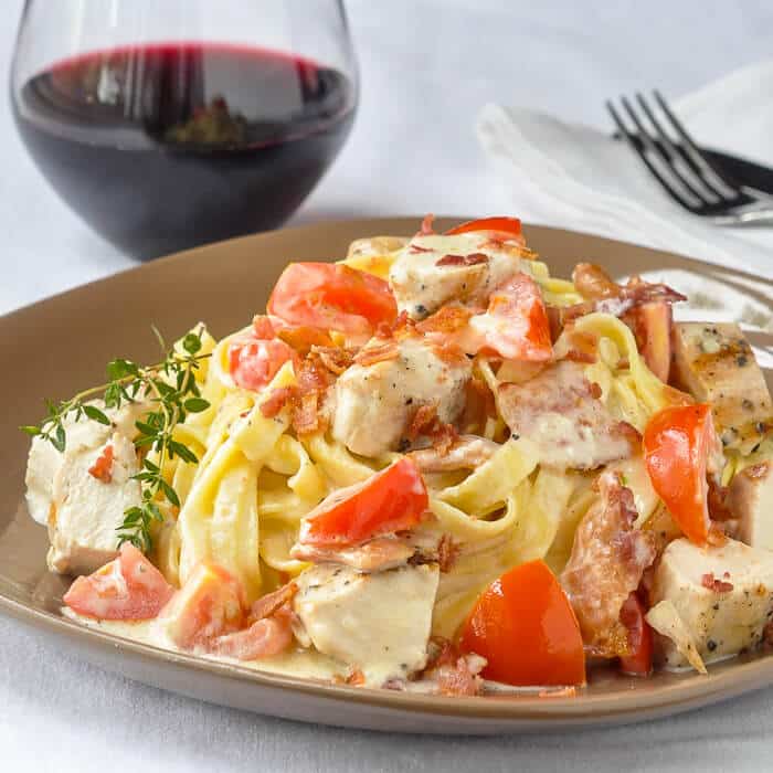 Fettuccine Alfredo with grilled chicken bacon and tomato