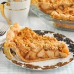 Deep Dish Apple Crumble Pie featured photo of a slice of cake on a white and gold plate