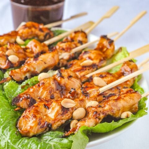 Peanut Butter Sriracha Chicken Satay on a bed of lettuce