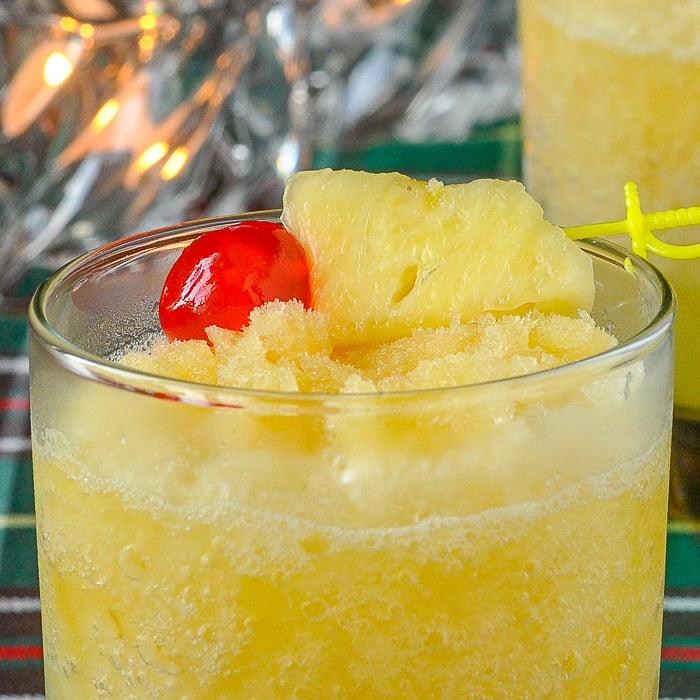 Newfoundland Christmas Slush close up image showing pineapple and cherry garnish