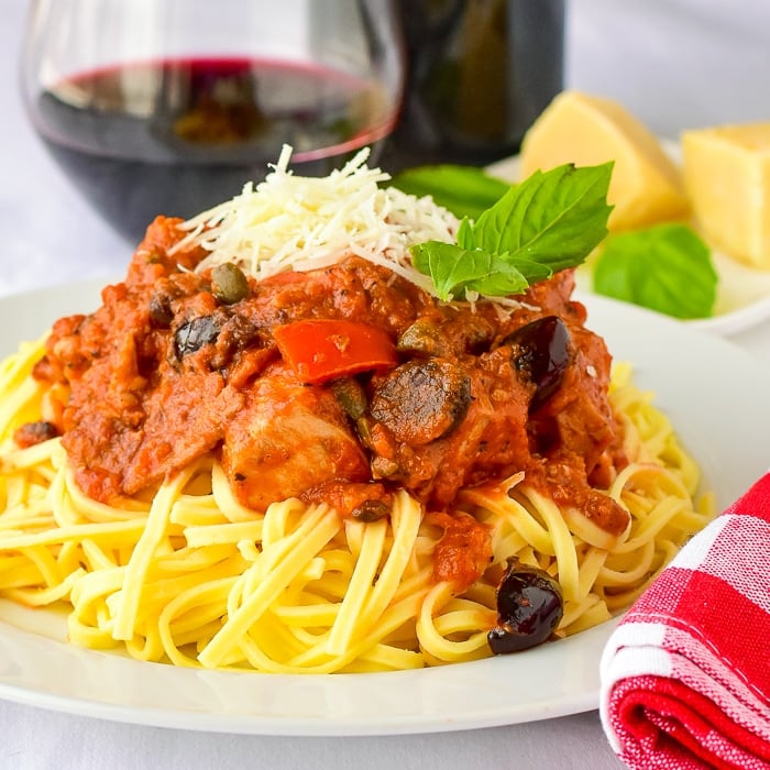 Chicken Amatriciana close up photo of a single serving on a white plate