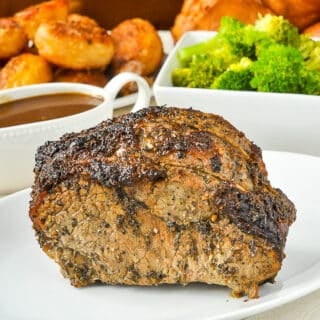 Worcestershire Butter Roast Beef shown with gravy, broccoli and roasted potatoes