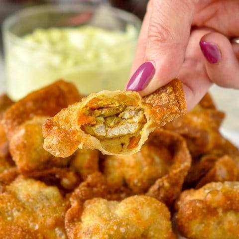 Curry Chicken Stuffed Wontons close up photo of one wonton broken open to reveal the curry chicken filling