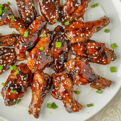 Glazed Teriyaki Chicken Wings close up photo on white plate