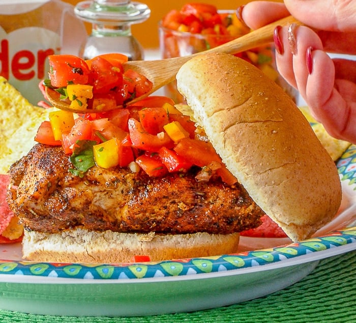 Adding salsa to a Mexican Spice Grilled Chicken Sandwich