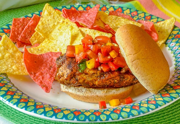 Mexican Spice Grilled Chicken Sandwich with tortilla chips on a multicoloured plate