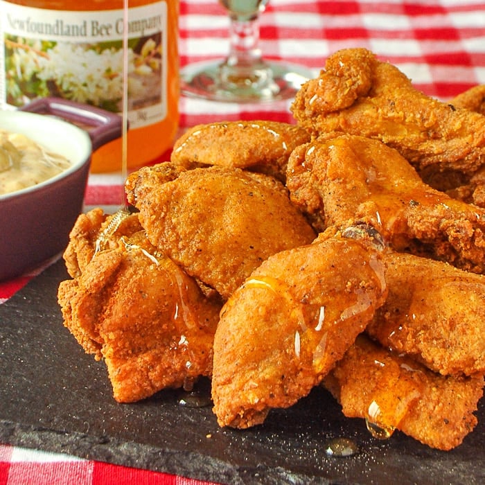 Close up photo of Southern Fried Wings being drizzled in honey