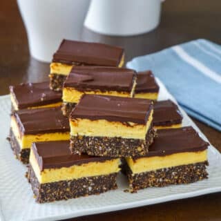 Nanaimo Bars shown on a serving plate.