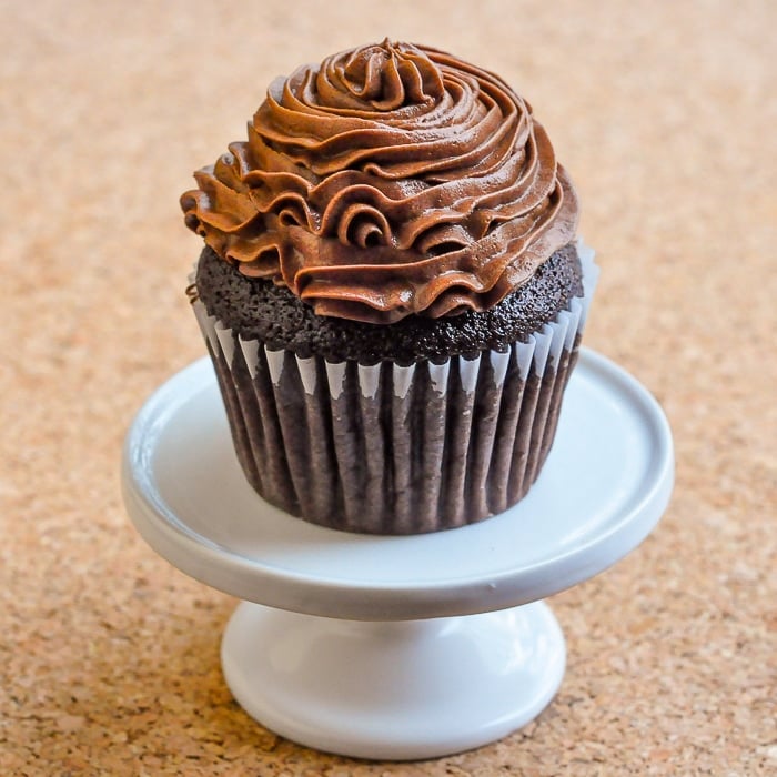 Perfect Chocolate Cupcakes photo of a singe cupcake on a white cupcake pedestal