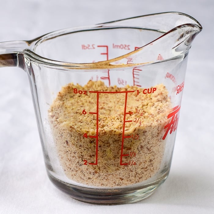 Ground almonds in a clear glass measuring cup