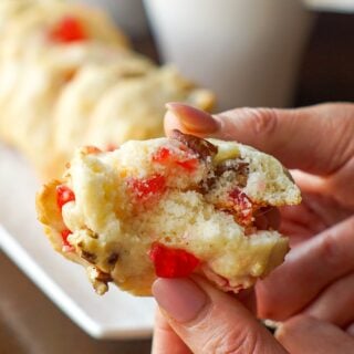 Cookie being broken open to show inside of these soft Cream Cheese Cookies