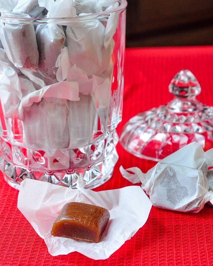 Homemade Chewy Caramels shown wrapped in crystal covered candy dish.