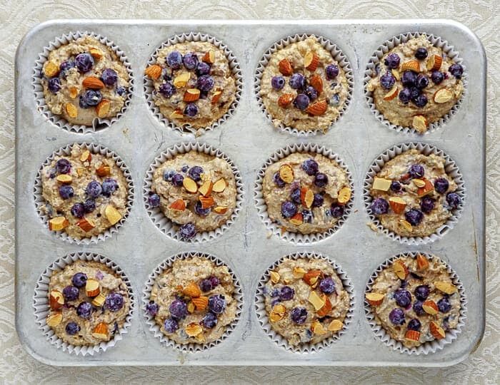 Blueberry Almond Butter Muffins in baking tray, ready for the oven, wide shot