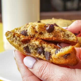 Banana Bread Cookies, shown broken in half with a soft center and melting chocolate chips.