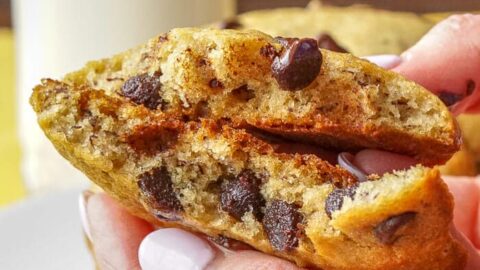 Banana Bread Cookies, shown broken in half with a soft center and melting chocolate chips.