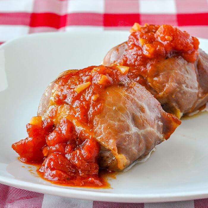 Stuffed Chicken Thighs with Prosciutto Mozzarella and Quick Tomato Sauce plated on white plate