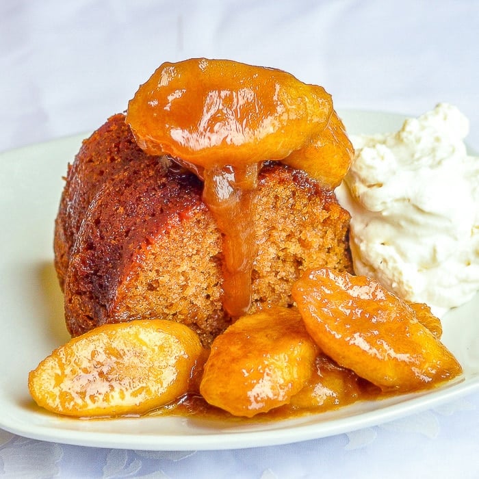 Honey Cake with Rum and Butter Bananas close up photo of a single slice on a white plate