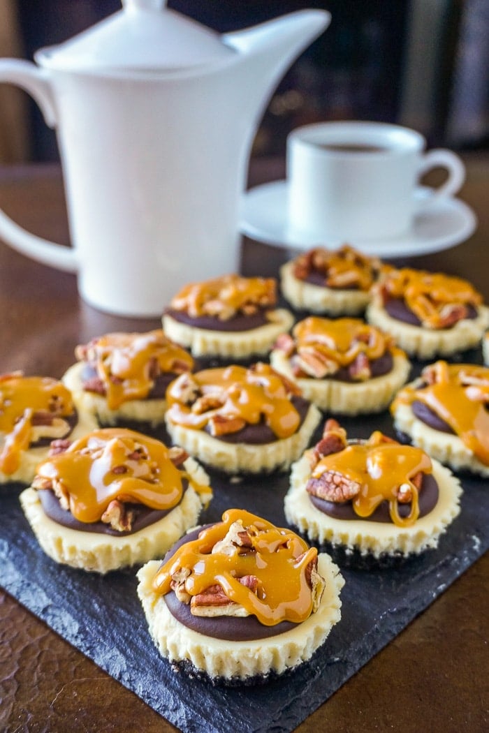 Mini Turtle Cheesecakes wide shot of finished cheesecakes on slate platter