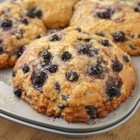 Bakery Style Blueberry Muffins close up of baked muffin still in the pan