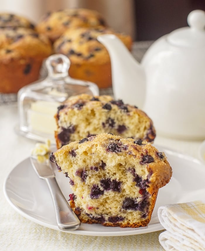 Bakery Style Blueberry Muffins cut in half to show the inside crumb structure