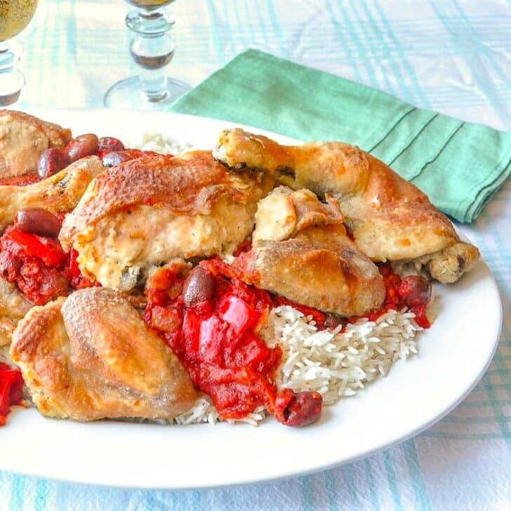 Chicken Cacciatore shown served with rice on a white platter