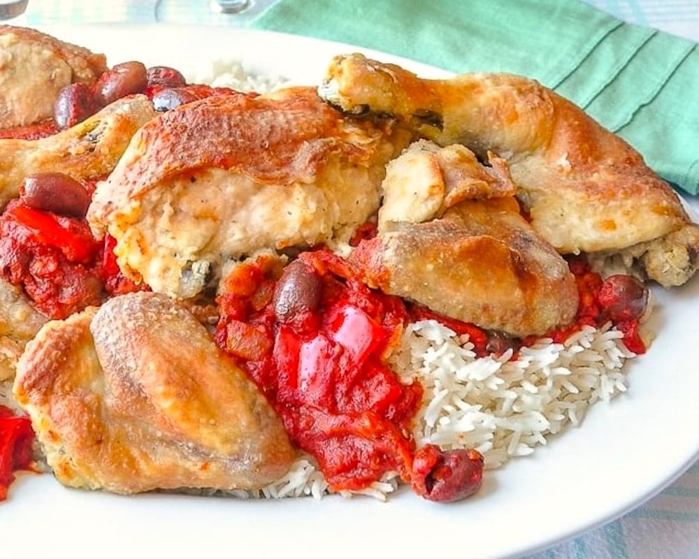 Close up photo of Chicken Cacciatore plated family style on a large white platter