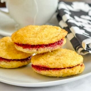 Raspberry Vanilla Butter Cookies close up photo of 3 cookies on a white plate.