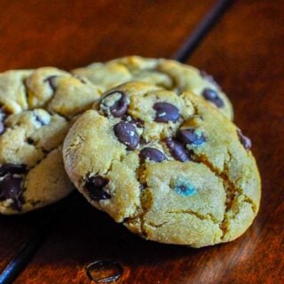 The Best Peanut Butter Chocolate Chip Cookies Close up photo of 1 cookie on a wooden table top