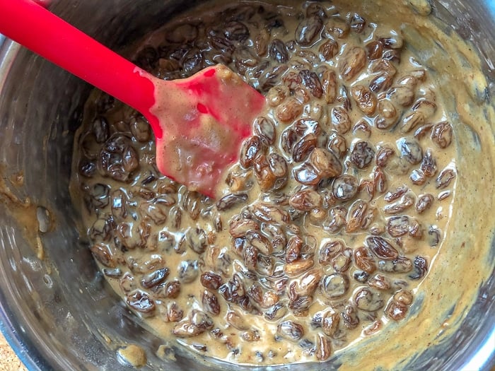 Combining the raisin mixture and cooked mixture for Rum Raisin Pie.