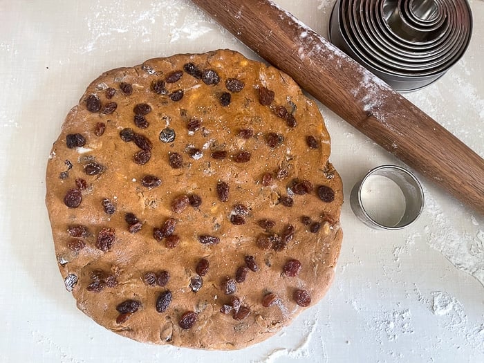 Roll the dough out and add extra raisins to the surface if you like