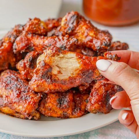 Whiskey Maple Barbecue Sauce close up photo of singe wing with bite taken