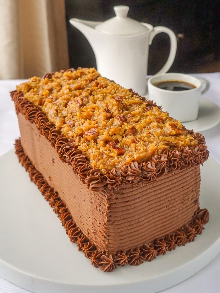 German Chocolate Cake photo of full uncut bar cake on a white cake plate